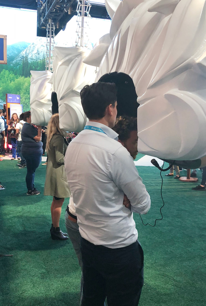 Guests interacting with an Einstein bobblehead's oversized hair and headset rig