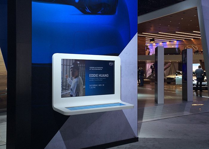 Guests gathered around the Scion touchscreen interactives